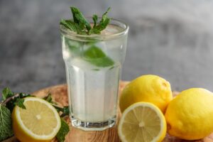 Drink A Glass Of Juice When You Feel Like Having A Cigarettes beside sliced limes